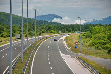 Highway traffic from above with mountain landscape in background