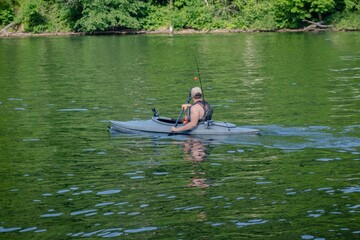 Landscape shot of a man kayaking and fishing