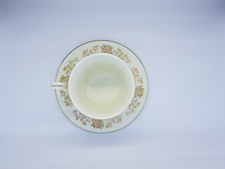 Sugar bowl with flower, tea cup and small jug for milk.