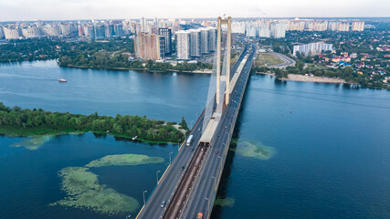 Aerial top view of South Bridge in Kiev city from above, Kyiv skyline and Dnieper river cityscape, Ukraine

