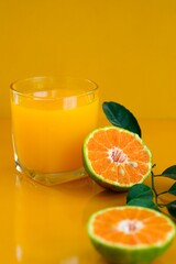 Orange juice isolated on yellow background.