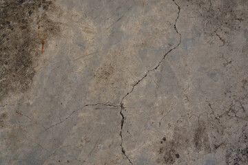 Line of old grey concrete surface cracking on the floor
