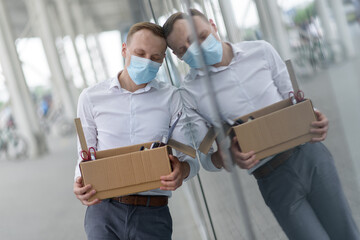 Dismissal of an employee due to epidemic of coronavirus. Dismissed employee sper against the wall...