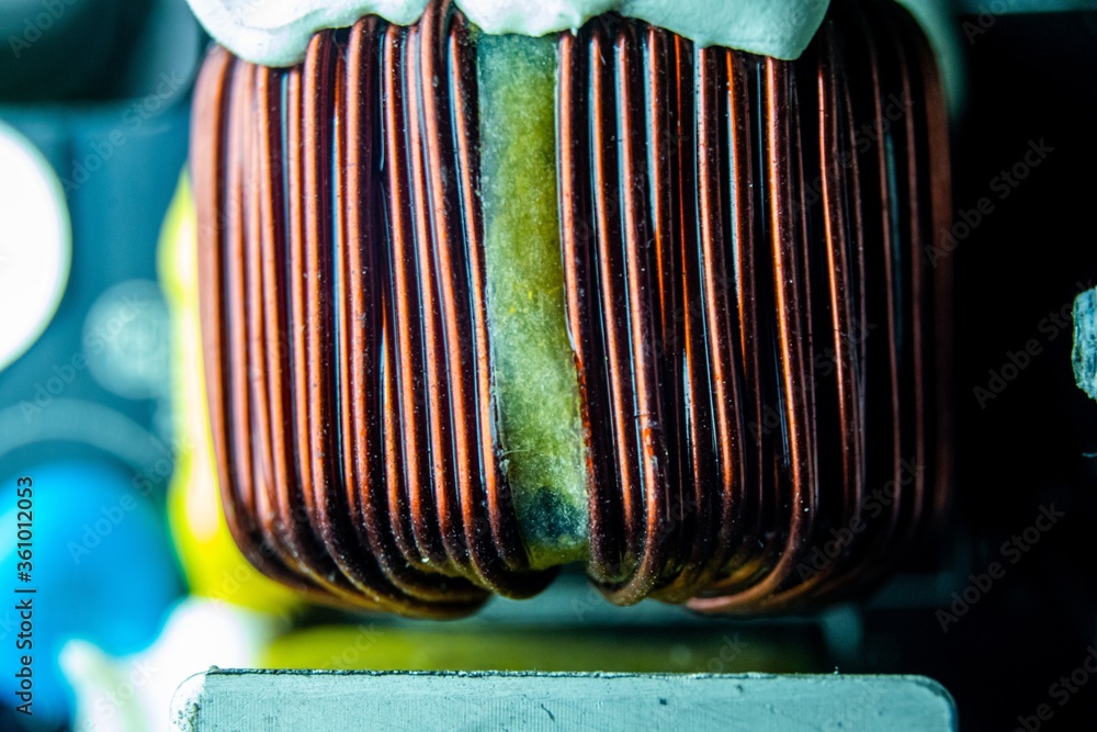Poster closeup of the inductor of a computer under the lights with a blurry background