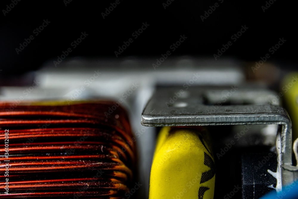 Poster closeup of the inductor of a computer under the lights with a blurry background