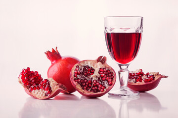 Ripe pomegranate fruit and pomegranate juice. Pomegranate juice in glass.