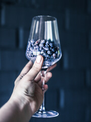 hand holds a glass with honeysuckle