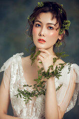 Fototapeta premium Asian girl with green grass as headdress