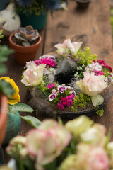 Flower wreath with roses on a garden table