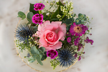 Old coffee cup with flower arrangement on a table