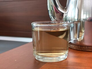 Close up a glass of tea on wooden table