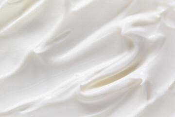 Fototapeta na wymiar Cream texture background. Greek yogurt, sour cream closeup. White natural creamy dairy product macro top view