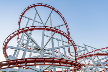 tracks of Roller coaster against blue sky, Perspective Concept