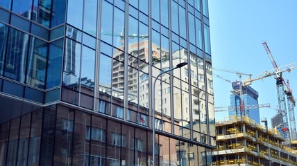 Fototapeta na wymiar Building site with cranes and blue sky