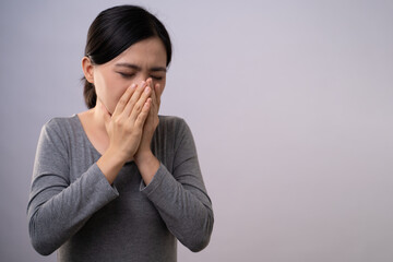 Asian woman was sick with sore throat standing isolated on background.