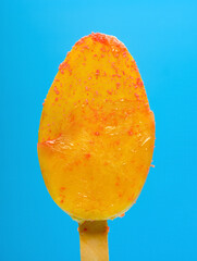 fresh orange flavor popsicle on a blue background