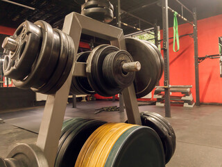 Pancakes for the bar hang on a rack in the gym.