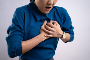 Asian woman was sick with chest pain standing isolated on background.