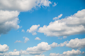 Naklejka na ściany i meble Beautiful background of blue sky with fluffy clouds