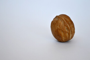 Single walnut on a white background