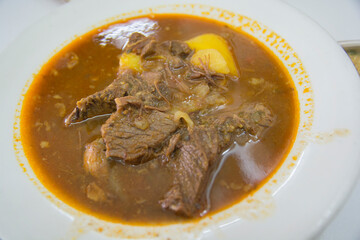 Traditional Yemenite beef soup, served in a white bowl 