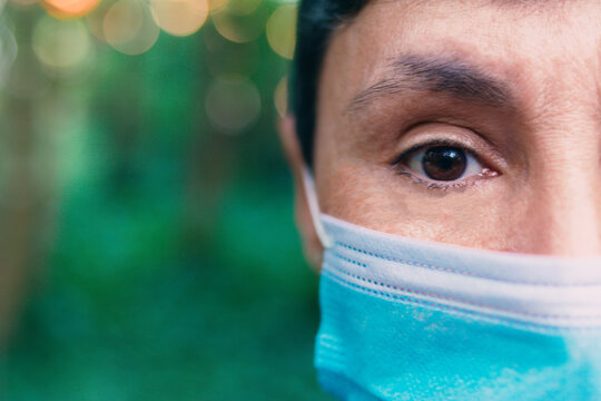 Half Face Of Middle Aged Woman With Face Mask