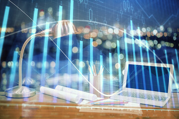 Financial chart drawing and table with computer on background. Multi exposure. Concept of international markets.
