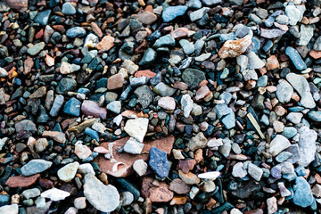 Small stones on the river bank. Stone texture concept