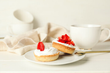 Plate with tasty tartlets on table