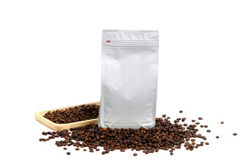 Mock-up plastic paper bag lying at coffee beans isolated on white background. Aluminium coffee...