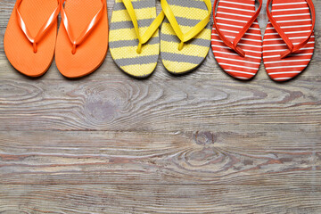 Stylish flip-flops on wooden background
