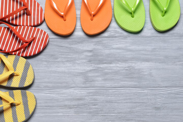 Stylish flip-flops on wooden background