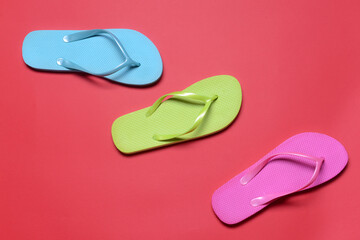 Stylish flip-flops on color background