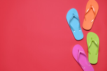 Stylish flip-flops on color background
