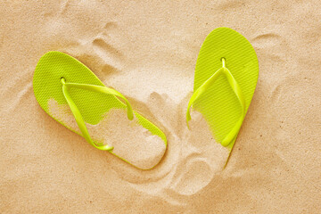 Stylish flip-flops on beach sand