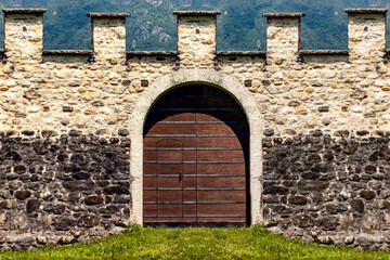 Detail of an old door and a castle boundary wall