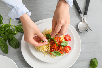 Woman cooking tasty pasta bolognese, closeup