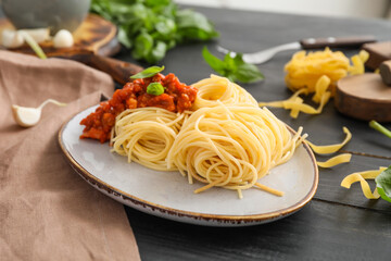 Plate with tasty pasta bolognese on table