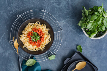 Plate with tasty pasta bolognese on dark background