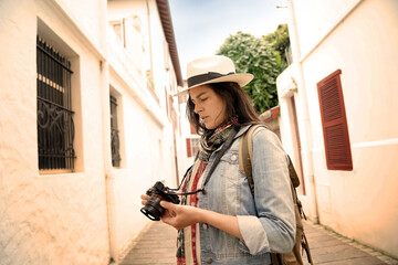 Woman visiting town taking pictures of architectural details with reflex camera