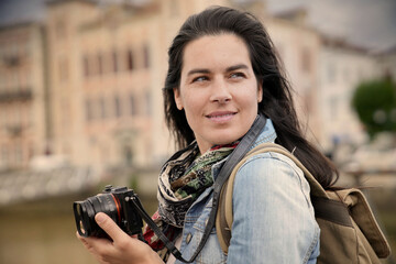 Portrait of woman reporter taking pictures with reflex camera