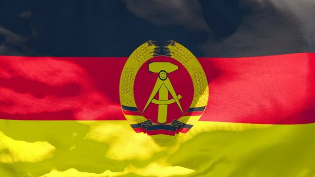 The national flag of German Democratic Republic flutters in the wind