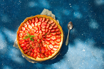 Fresh homemade strawberry shortcrust tart pie stuffed with custard vanilla cream . Sliced berries...