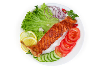 Grilled trout fillet among the vegetables and greens, top view