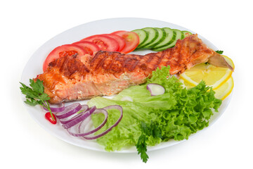 Portion of grilled trout fillet among the vegetables and greens