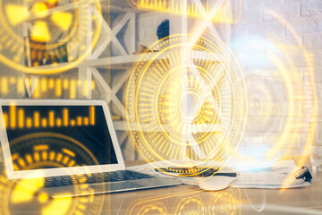 Computer on desktop in office with technology theme hologram. Multi exposure. Tech concept.