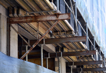 part of new bilded wall on construction site with steel rails and concete elements.