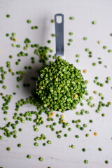 green split peas in a measuring cup