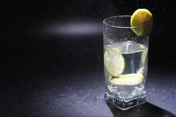 Lime water. Drinking water with fresh lime. Mineral water. Healthy, mineral-rich, refreshing water with lime.
