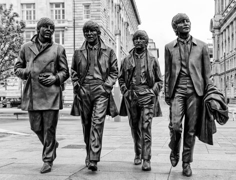 Liverpool, England - May 28, 2017: Bronze Statues of The Beatles located on Pier Head, They were created by Andy Edwards and unveiled in December 2015